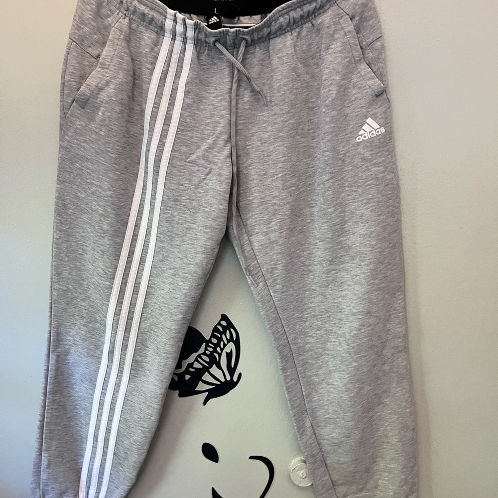 Adidas joggers gray with the white Adidas 3 stripes down front leg